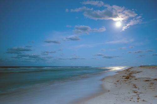 Full moon over the coastline at the beach - Australian Stock Image