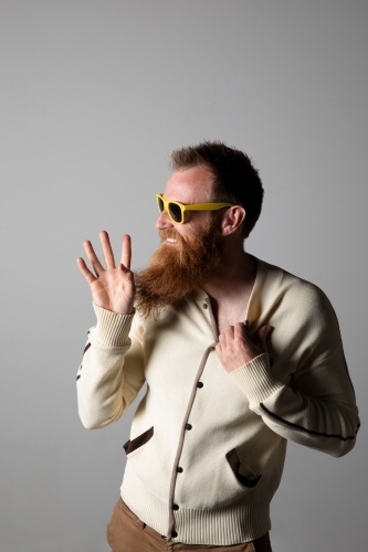 Funky man posing for photographs, wearing a beige shirt