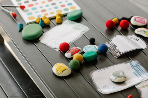 Funny looking monsters painted acrylic on pebbles. - Australian Stock Image