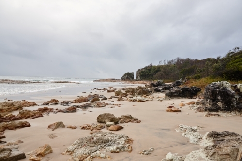 Gap in coastal rocky headland landscape on overcast morning - Australian Stock Image