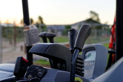 Gear levers and equipment on inside of mini excavator digger - Australian Stock Image