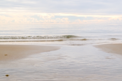 gentle morning waves touching the shore - Australian Stock Image