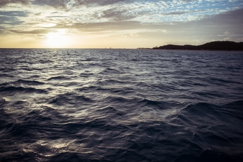 Gentle ripples and waves of the sea with a visible horizon - Australian Stock Image