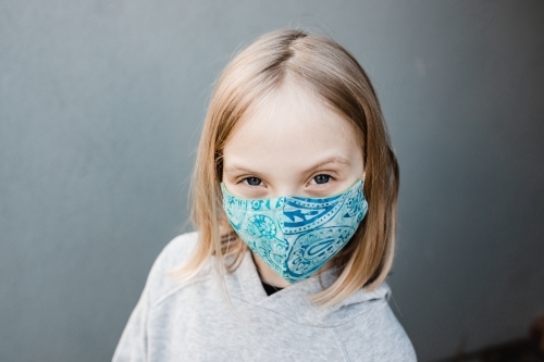 girl child wearing fabric masks during the corona COVID-19 pandemic, masks are now compulsory. - Australian Stock Image