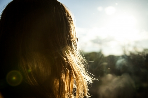 Girl looking at the sun - Australian Stock Image