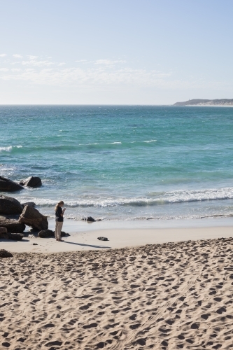 Girl photographing regional australian beach - Australian Stock Image