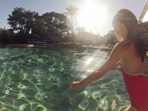 Girl ready to dive into a swimming pool - Australian Stock Image