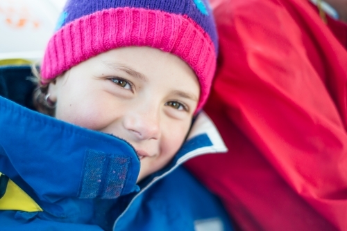 Girl rugged up warm in jacket with beanie - Australian Stock Image