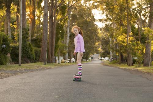 Girl skateboarding in a street - Australian Stock Image