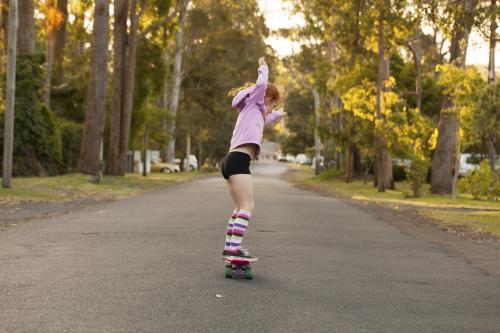 Girl skateboarding in a street - Australian Stock Image