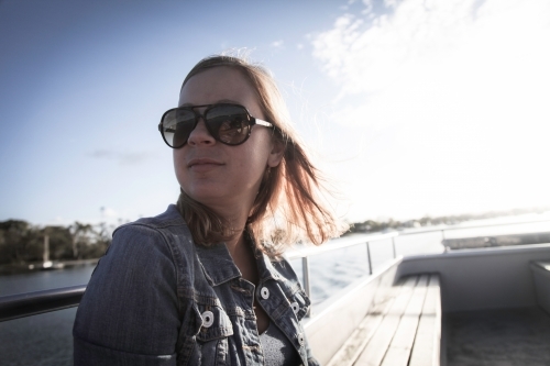 Girl wearing sunnies boat - Australian Stock Image