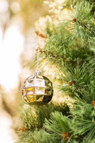 Golden Christmas bauble with bokeh copy space - Australian Stock Image