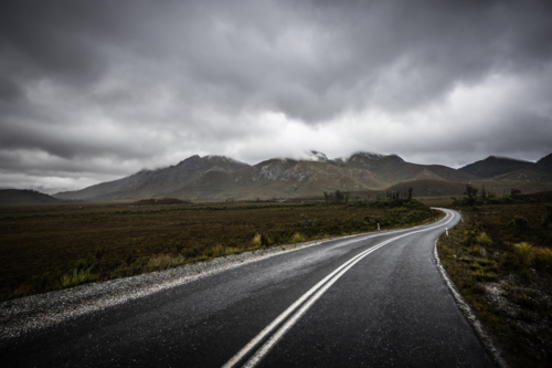 Gordon River Rd at the Sentinel range of mountains on overcast day - Australian Stock Image