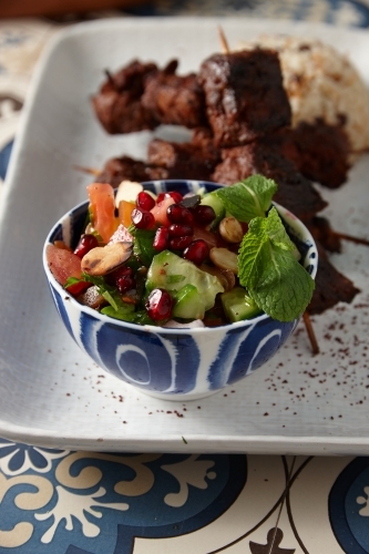 Gourmet Lebanese salad and kebabs on plate - Australian Stock Image