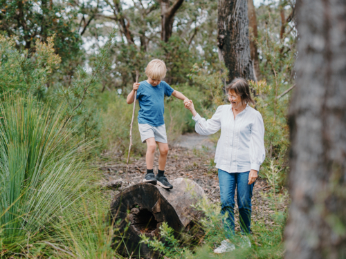 Grandmother spending time with grandson in nature exploring the bush - Australian Stock Image