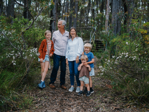 Grandparents enjoying Australian Bushland with their Grandchildren smiling happily together - Australian Stock Image