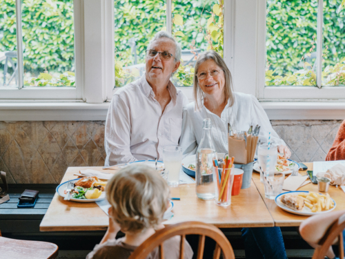 Grandparents enjoying lunch with their young grandchildren - Australian Stock Image