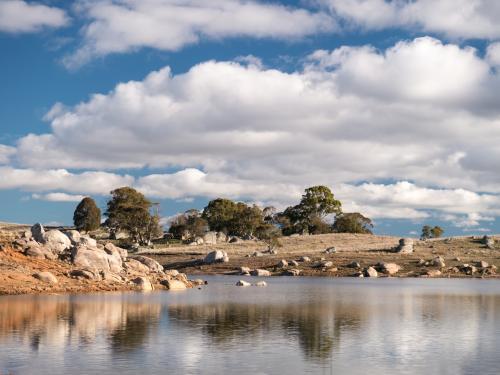 Granite rock lake scene on a sunny day with scattered cloud