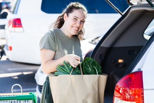 Green healthy environmentally friendly lifestyle - woman using paper shopping bags - Australian Stock Image