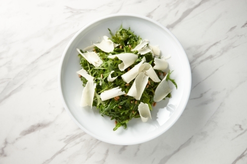 green salad mixed with nuts and shaved cheese - Australian Stock Image