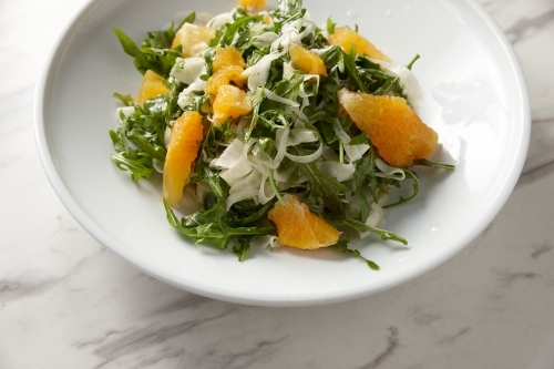 green salad with orange slices and grated cheese - Australian Stock Image