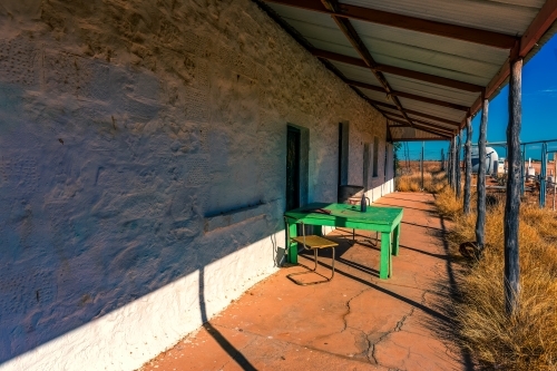 Green table on veranda of Old Betoota Hotel - Australian Stock Image