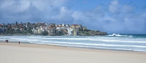 grey clouds hanging over Bondi beach on a quiet but windy day - Australian Stock Image