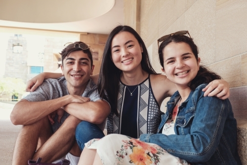 Group of happy international students in university library - Australian Stock Image