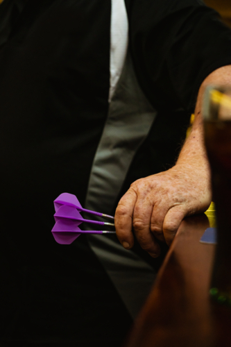 Guy holding 3 darts - Australian Stock Image