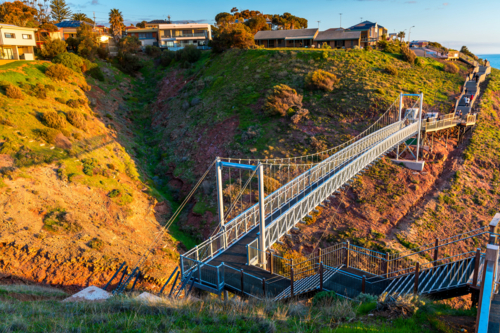 Hallett Cove newly constructed suspension bridge with people at sunset, South Australia - Australian Stock Image