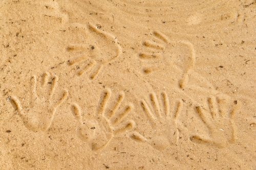 Handprints pressed into the sandy surface. - Australian Stock Image