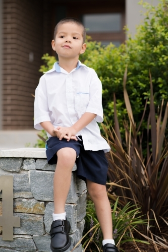 Handsome boys in school uniform leave home for their first day of school