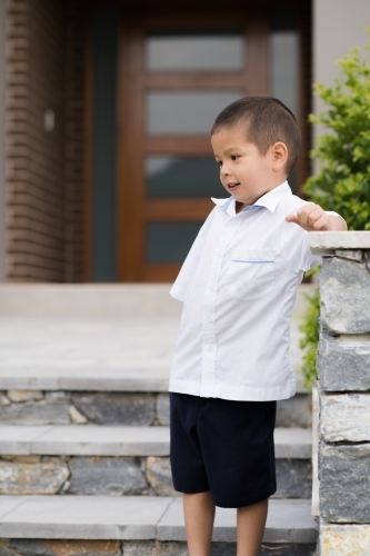 Handsome boys in school uniform leave home for their first day of school - Australian Stock Image