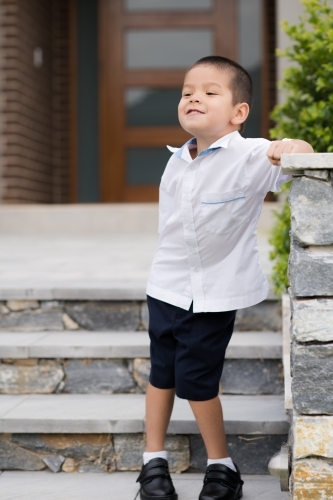 Handsome boys in school uniform leave home for their first day of school - Australian Stock Image