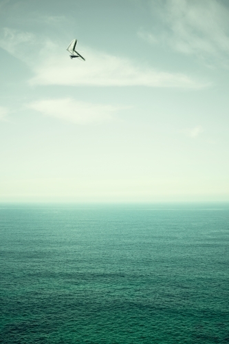 Hang gliding over the ocean on a beautiful day - Australian Stock Image