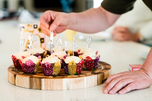 happy birthday candles on cupcakes - Australian Stock Image