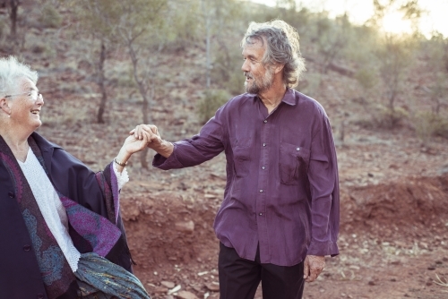 Happy elderly couple holding hands - Australian Stock Image