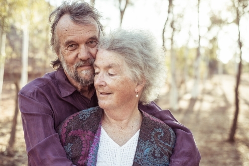 Happy elderly couple hug