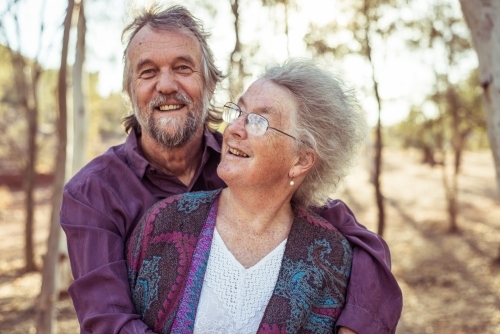 Happy elderly couple hug in the Northern Territory - Australian Stock Image