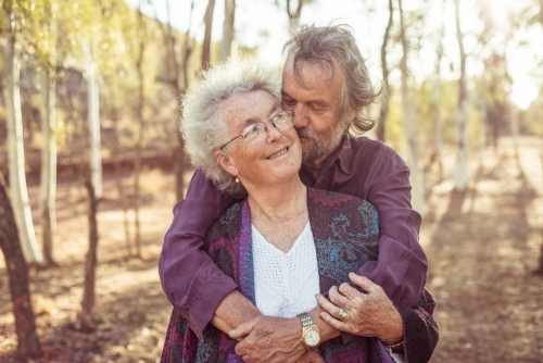 Happy elderly couple hug in the Northern Territory - Australian Stock Image