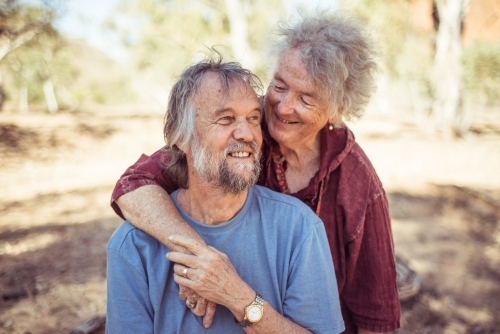 Happy elderly couple hug in the Northern Territory - Australian Stock Image