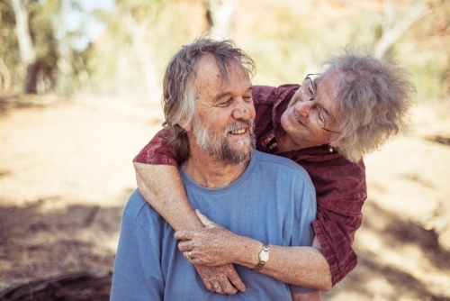 Happy elderly couple hug in the Northern Territory