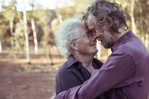 Happy elderly couple kiss in the Northern Territory - Australian Stock Image