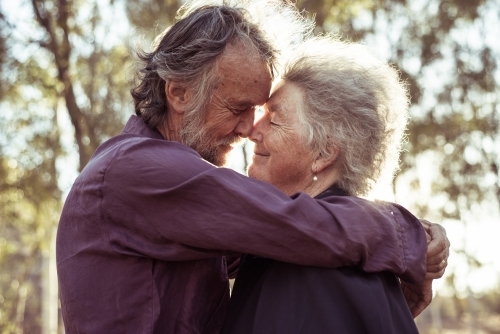 Happy elderly couple kiss in the Northern Territory - Australian Stock Image