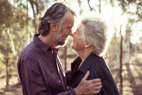 Happy elderly couple kiss in the Northern Territory - Australian Stock Image