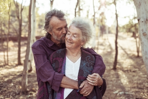 Happy elderly couple kiss in the Northern Territory - Australian Stock Image