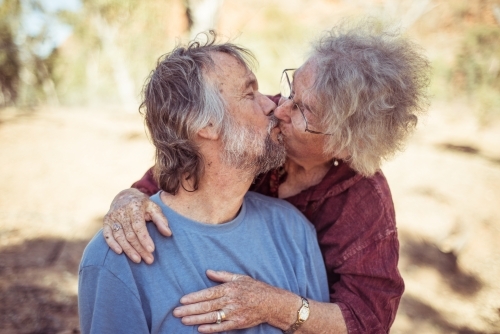 Happy elderly couple kiss in the Northern Territory - Australian Stock Image