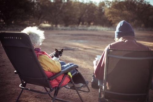 Happy elderly couple siting in camp chairs in the Northern Territory - Australian Stock Image