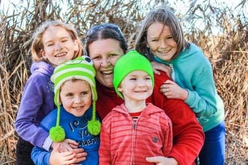 Happy family hugging and smiling - Australian Stock Image