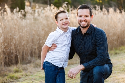 Happy father and young son portrait outside